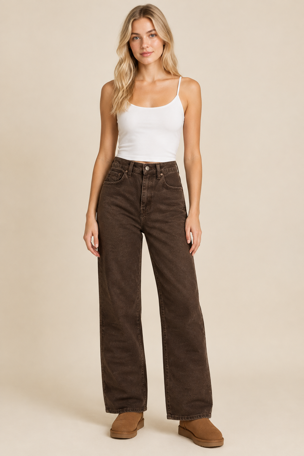 Brown jeans styled on a blonde model in a neutral studio
