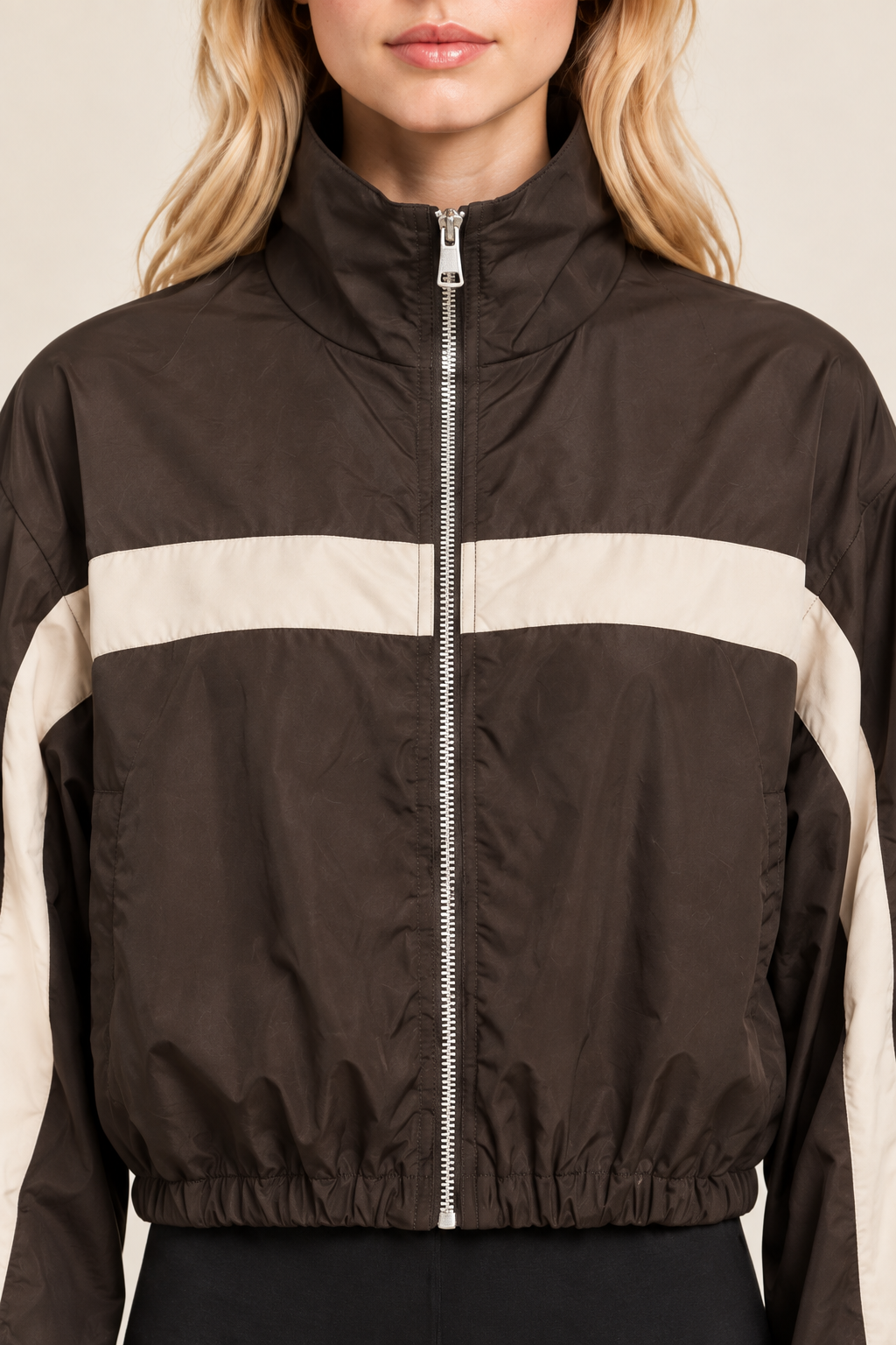 Close-up of brown striped track jacket on blonde model