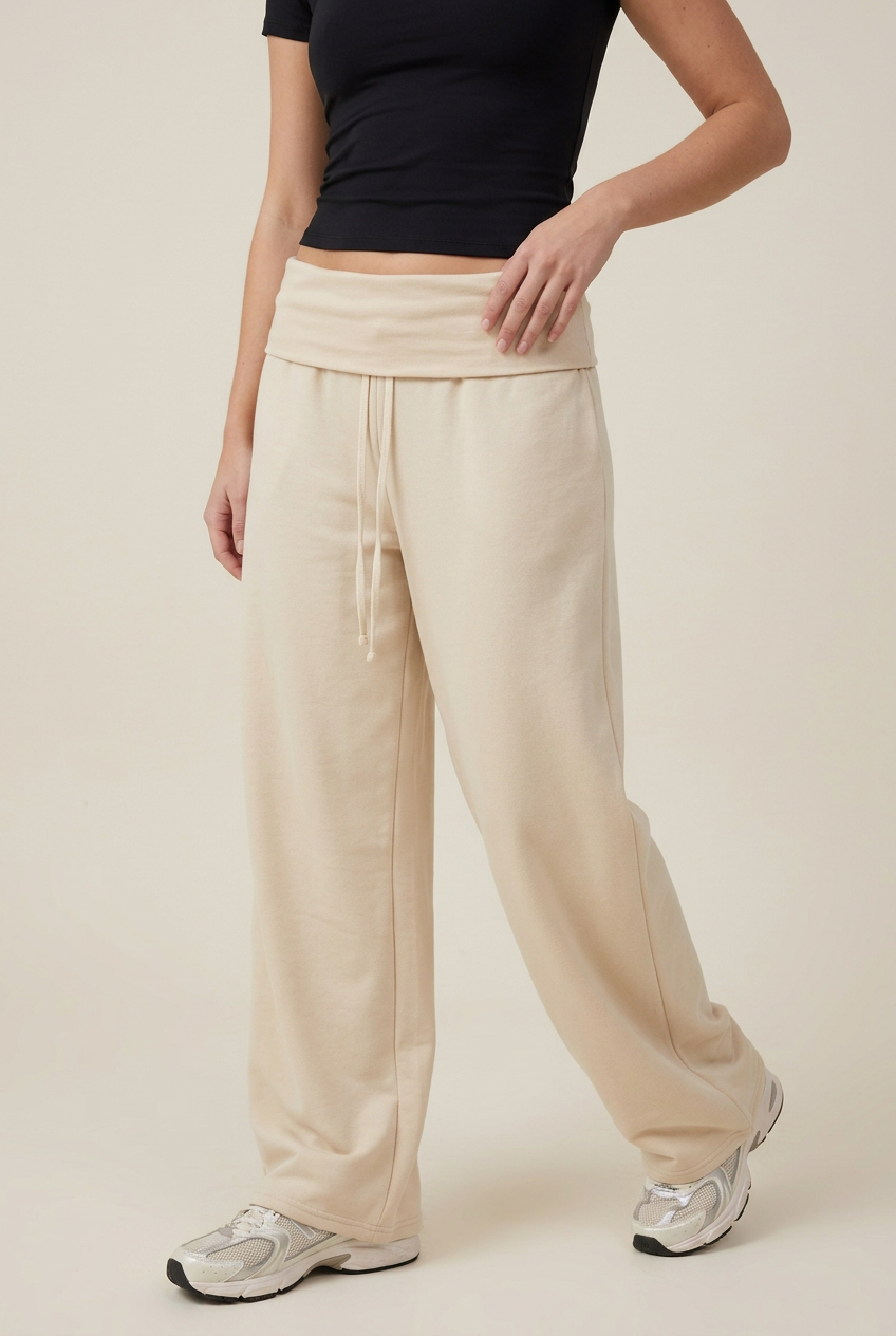 Close-up of the cream trousers in a new angled pose