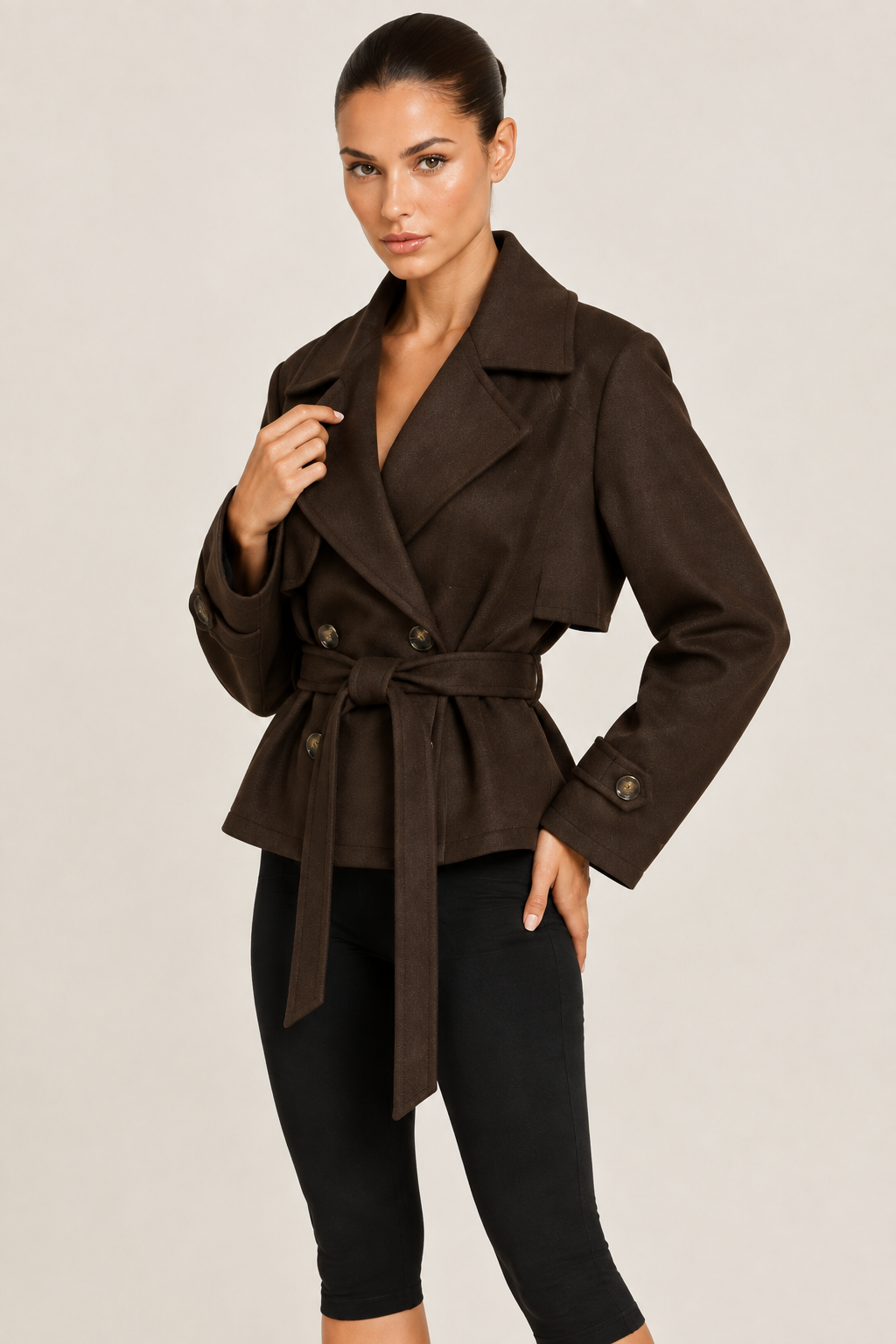 Close-up studio image of the cropped wool trench