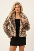 Front-facing close-up of the cropped leopard jacket, with the blonde model in a new hand-at-waist pose
