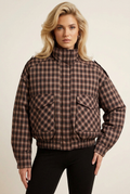 Front-facing close-up of the padded check coat with the model in a new pose