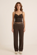 Front-facing studio image of the camisole and trouser set on the brunette model