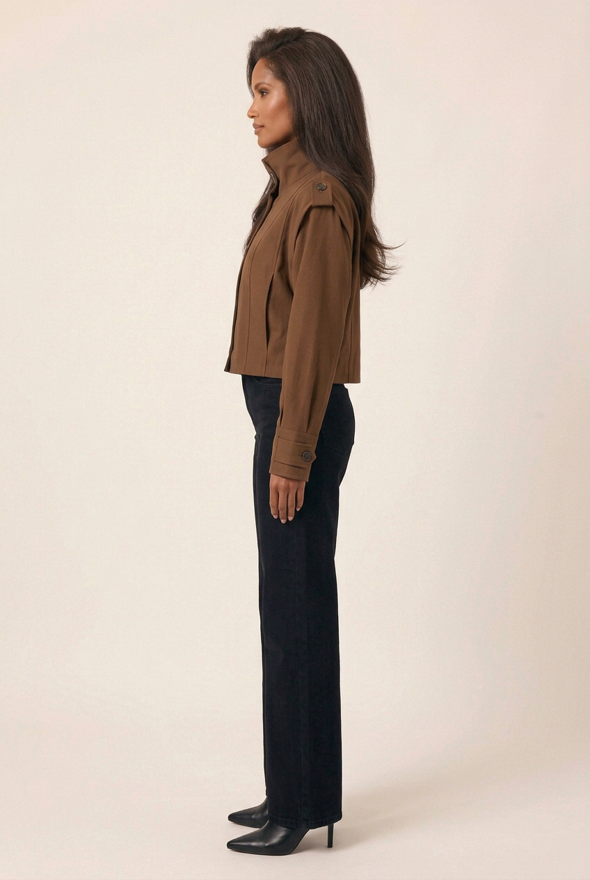 Full-length side profile of the brown stand-collar jacket with black wide-leg jeans and pointed-toe heeled boots