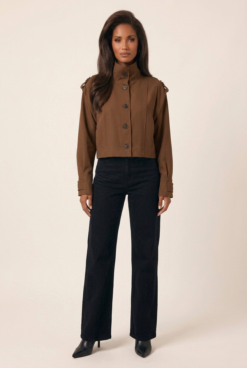 Full-length studio outfit with the brown stand-collar jacket, black wide-leg jeans and black pointed-toe heeled boots
