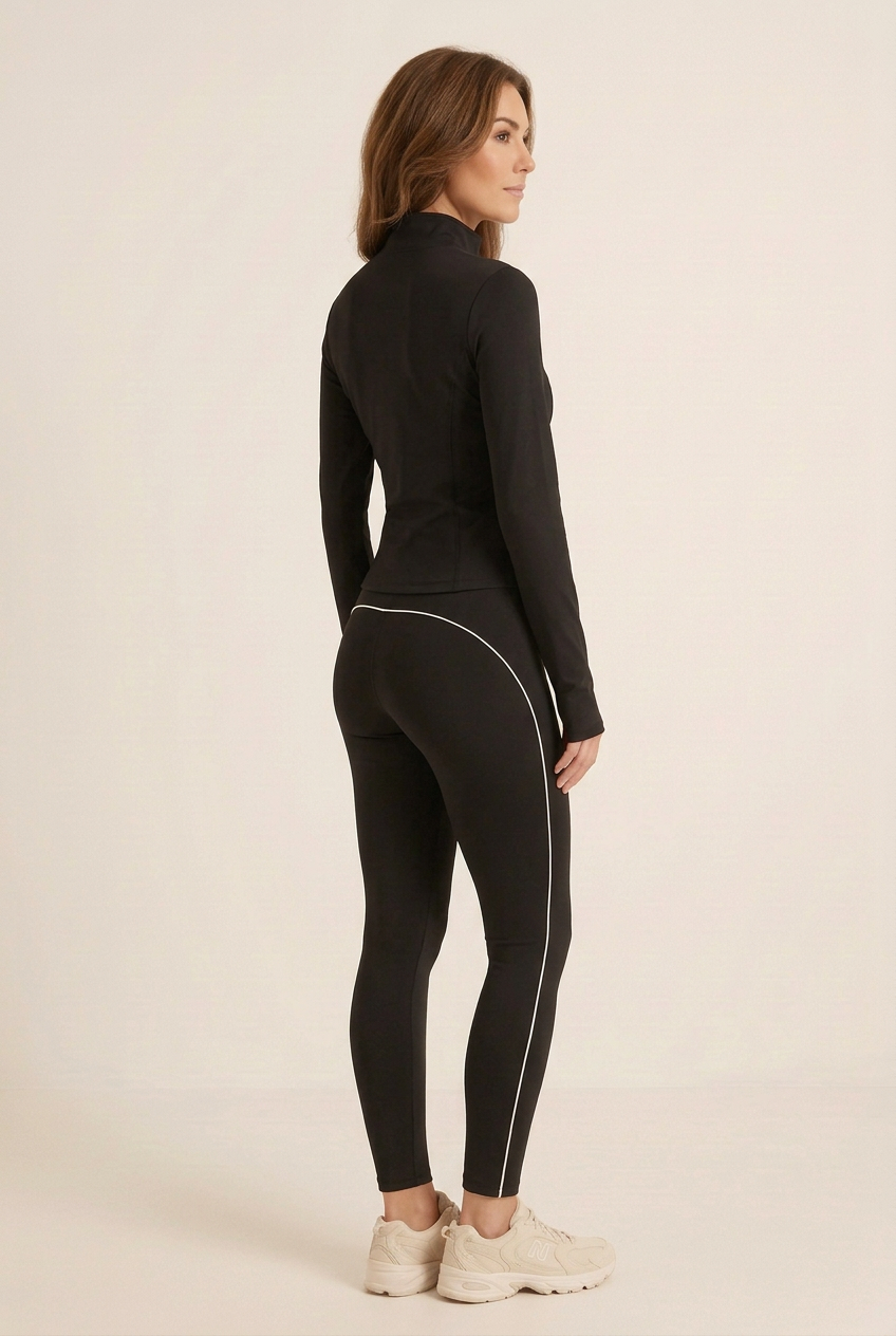 Refined studio side view highlighting the curved white piping across the hip and down the leggings