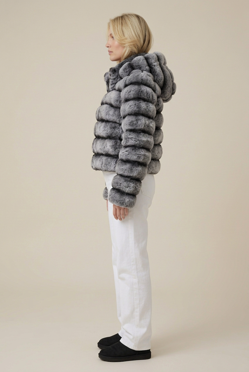 Side profile of the blonde model in the grey banded faux fur coat