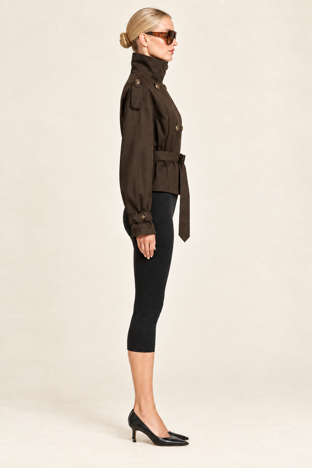 Side profile of the brown jacket look with tortoiseshell sunglasses, black capri leggings and kitten heels