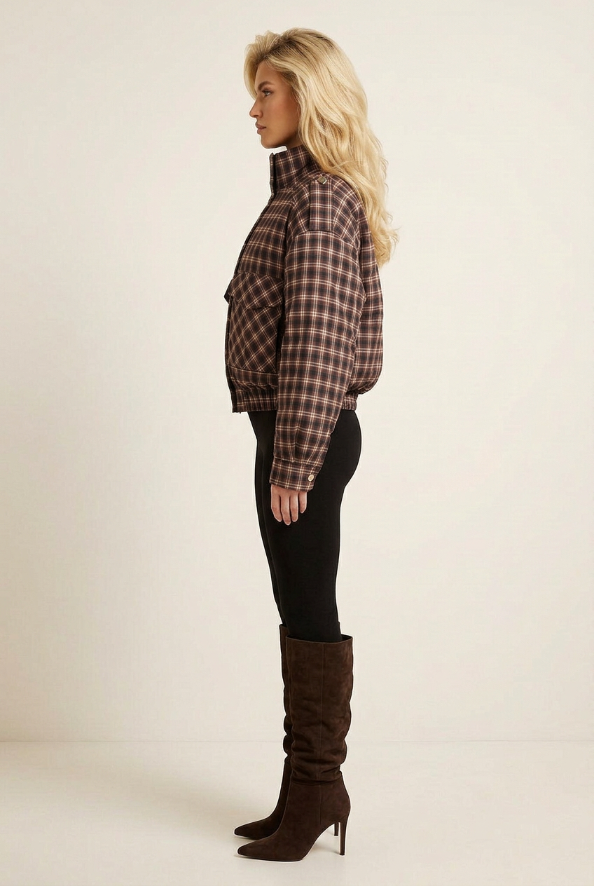 Side-profile studio image of the padded check coat with black leggings and dark brown slouchy suede boots