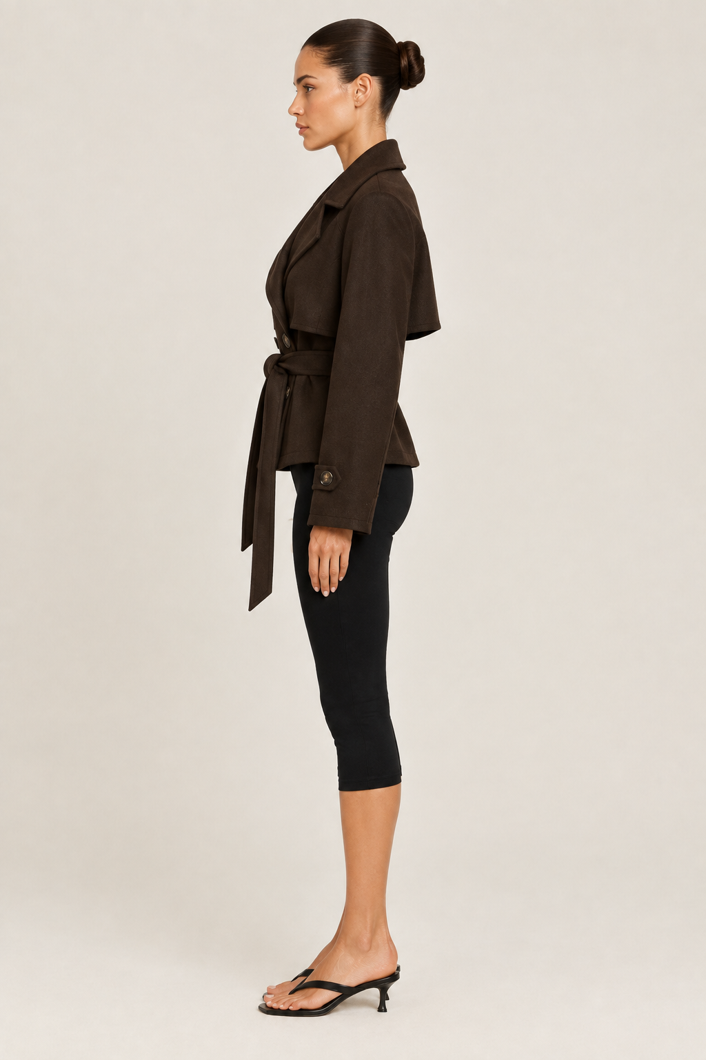 Side-profile studio image of the wool cropped trench